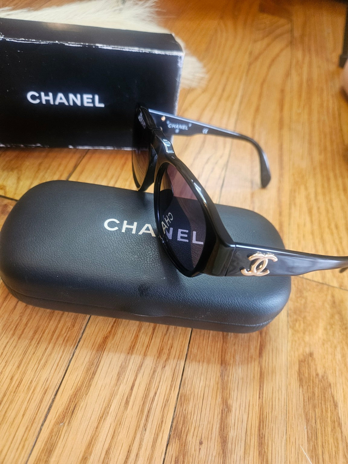 Chanel sunglasses with branded case side view
