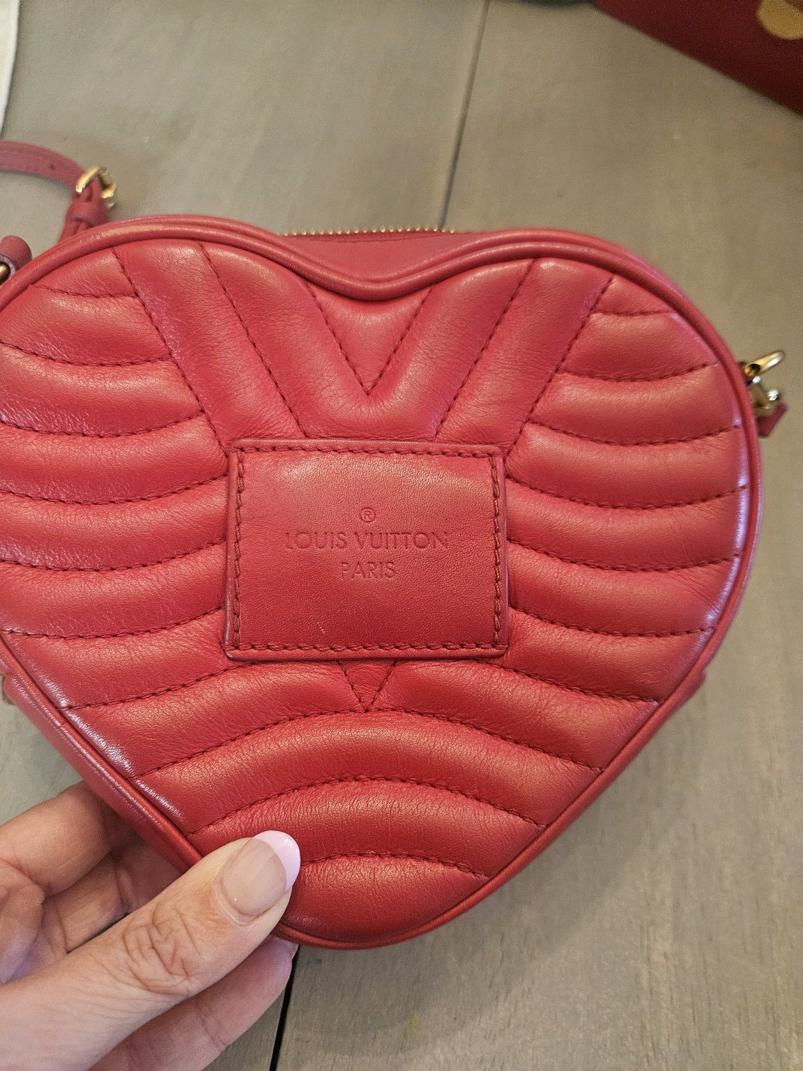 Enhanced photograph of red Louis Vuitton heart crossbody bag, detail 8