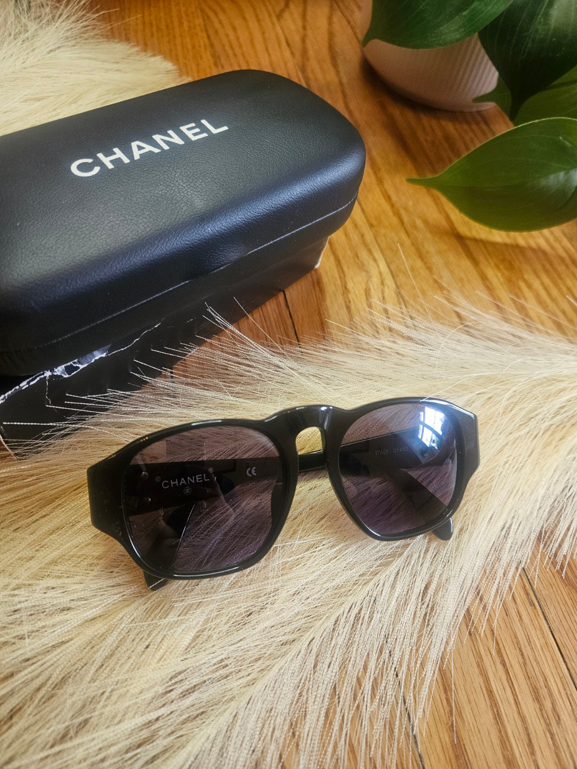 Chanel black sunglasses with case front view