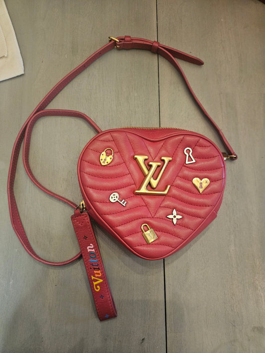 Red Louis Vuitton heart-shaped crossbody with strap and colorful Vuitton tag