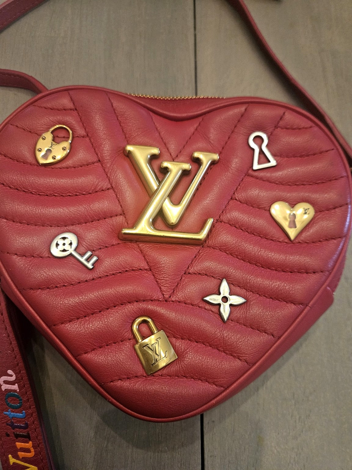 Enhanced photograph of red Louis Vuitton heart crossbody bag, detail 2
