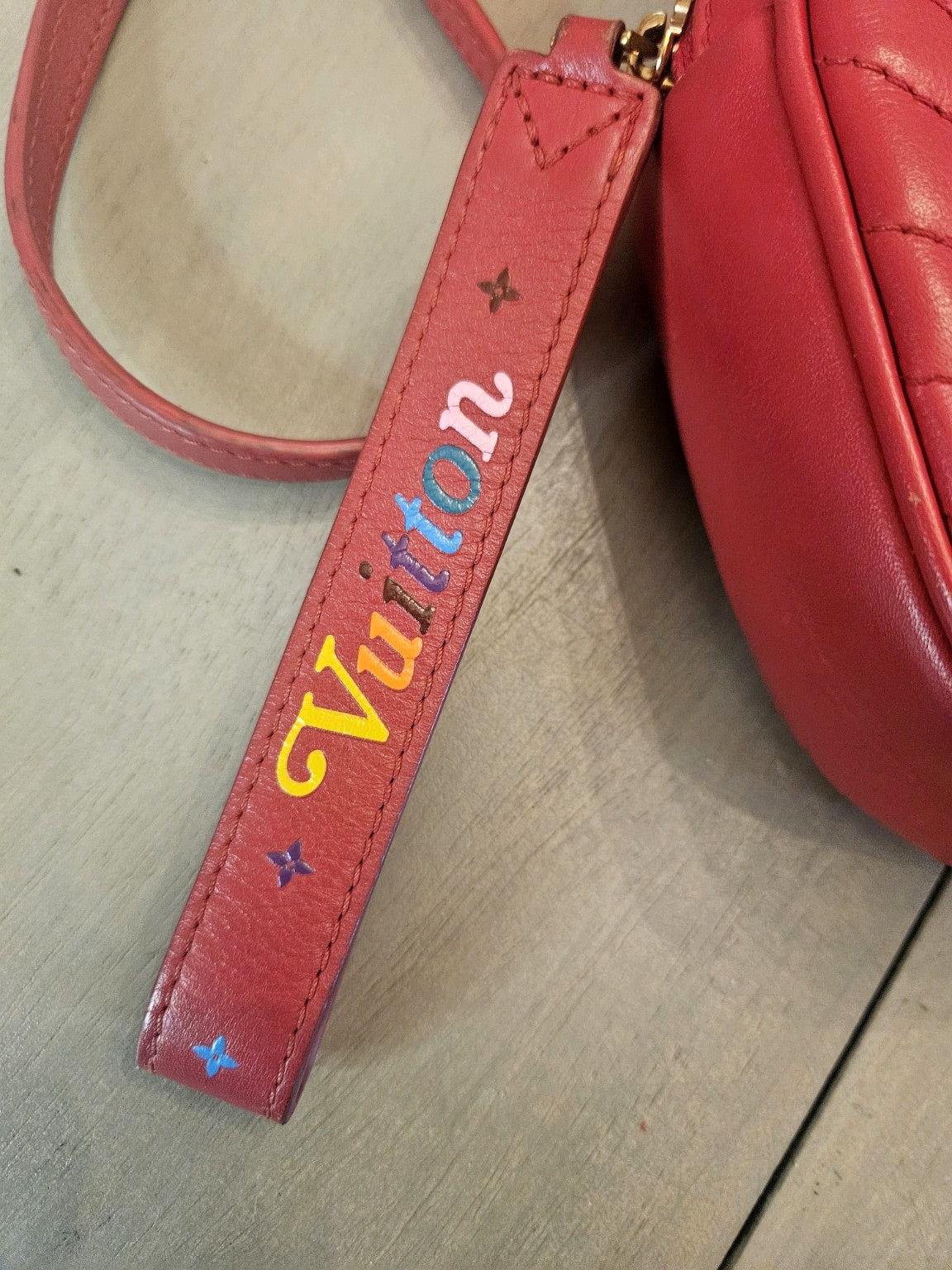 Enhanced photograph of red Louis Vuitton heart crossbody bag, detail 3