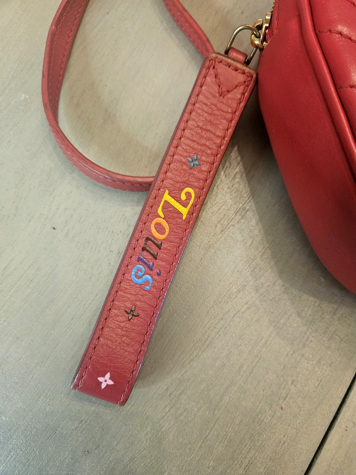 Enhanced photograph of red Louis Vuitton heart crossbody bag, detail 4