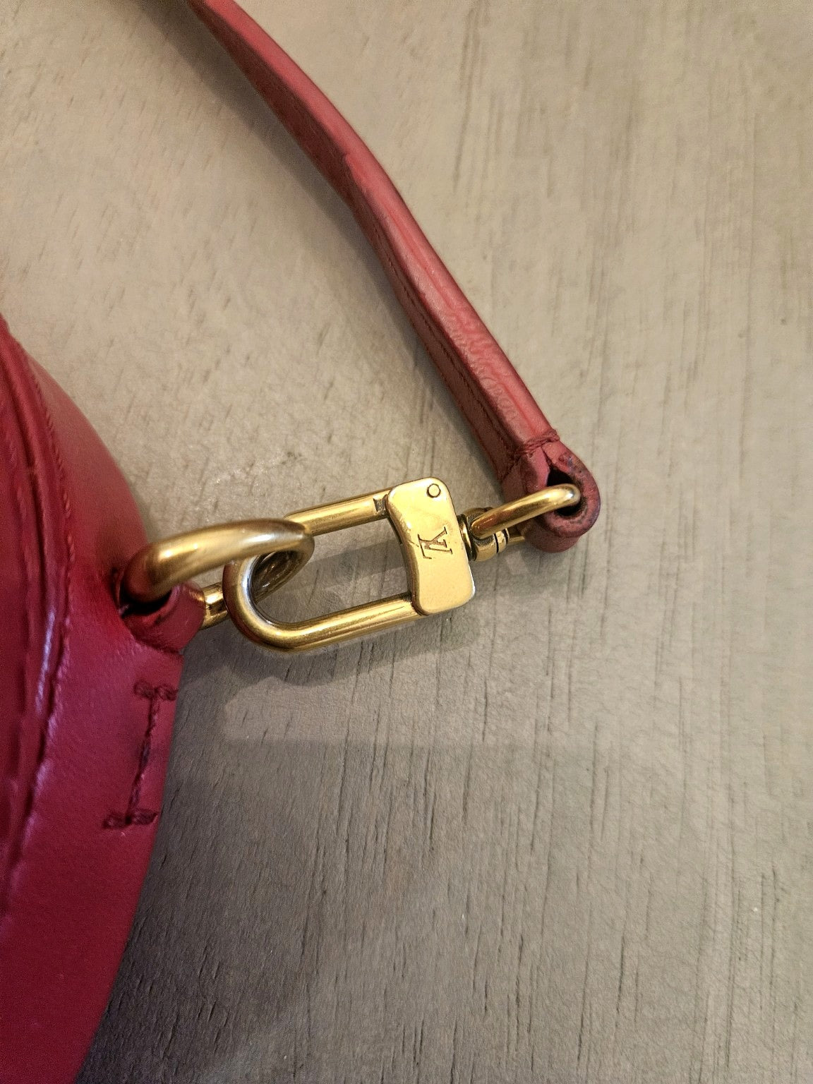 Enhanced photograph of red Louis Vuitton heart crossbody bag, detail 5