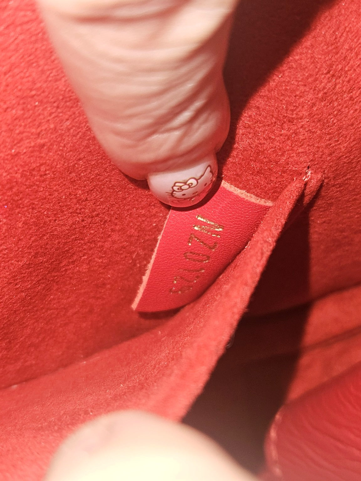 Enhanced photograph of red Louis Vuitton heart crossbody bag, detail 7