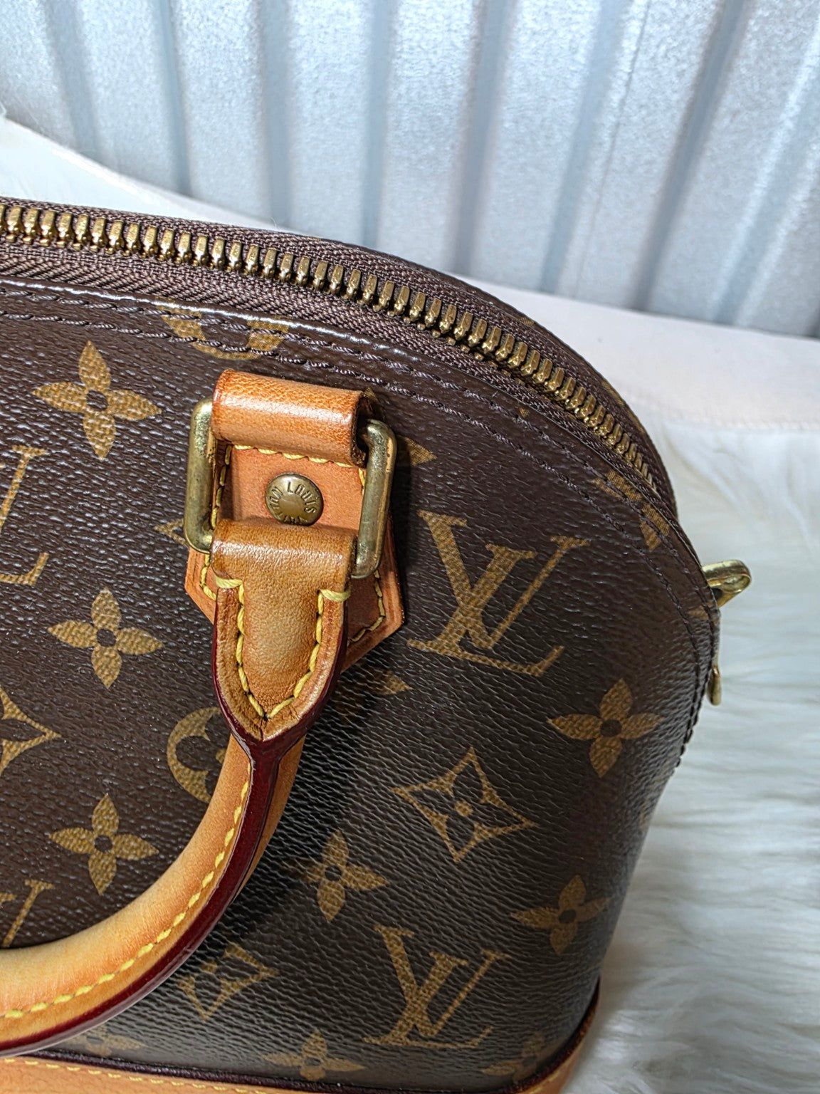 Close-up of second leather handle attachment and zipper