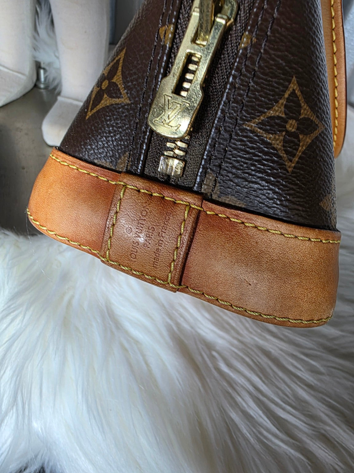 Close-up of zipper pull and stamped leather side tab