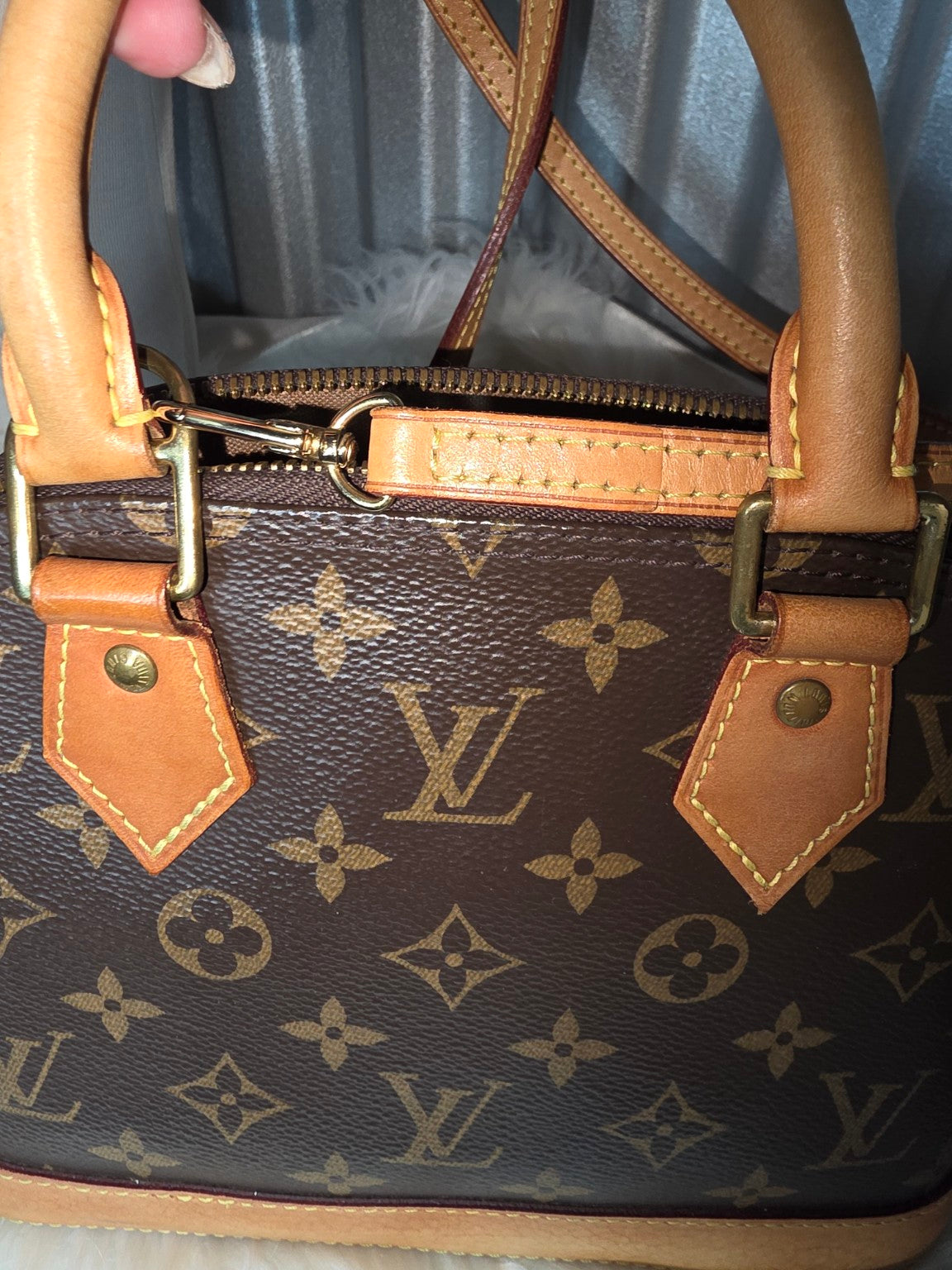 Top handles, shoulder strap and monogram canvas detail