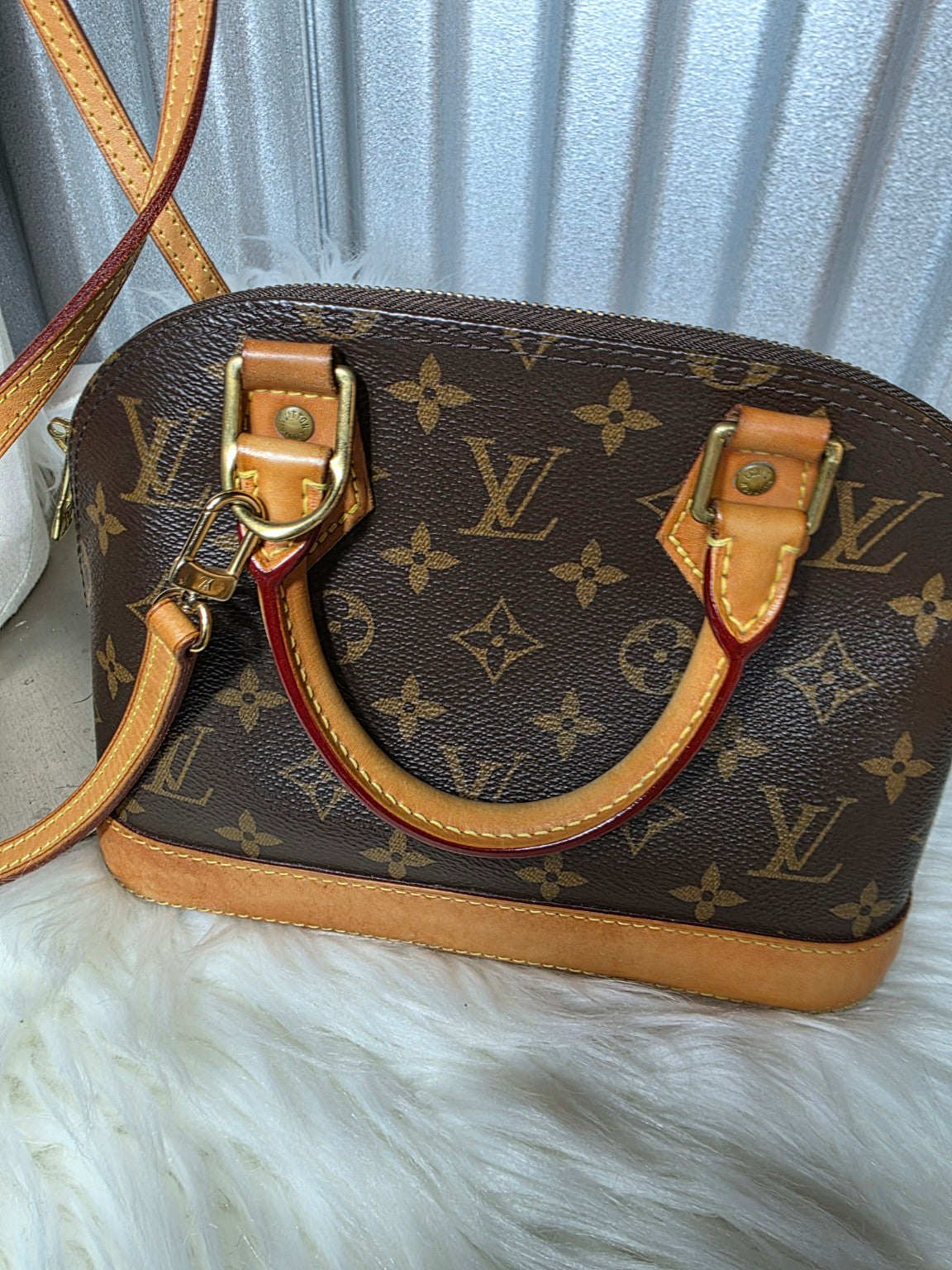 Close-up of Monogram handbag front and leather handles